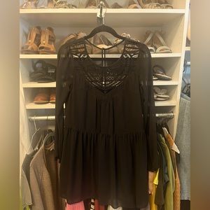 Black long sleeve express dress with sheer arms and neck.